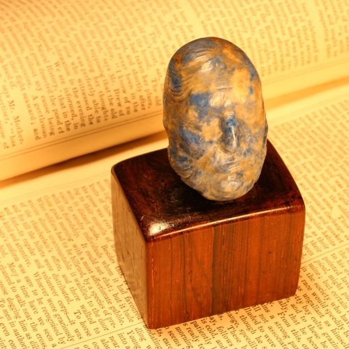 1227 - Alfred Lyndhurst Pocock (1882 - 1962), a lapis lazuli pebble carving, Socrates, 4cm long, mounted on... 