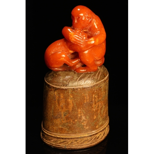 1270 - Alfred Lyndhurst Pocock (1882 - 1962), an amber carving, of monkeys, oval terracotta base, 9.5cm hig... 