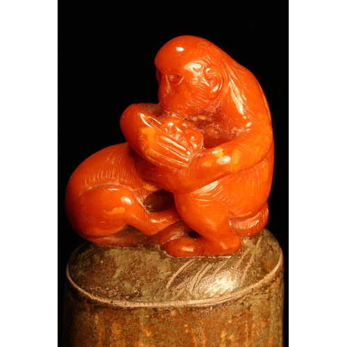 1270 - Alfred Lyndhurst Pocock (1882 - 1962), an amber carving, of monkeys, oval terracotta base, 9.5cm hig... 