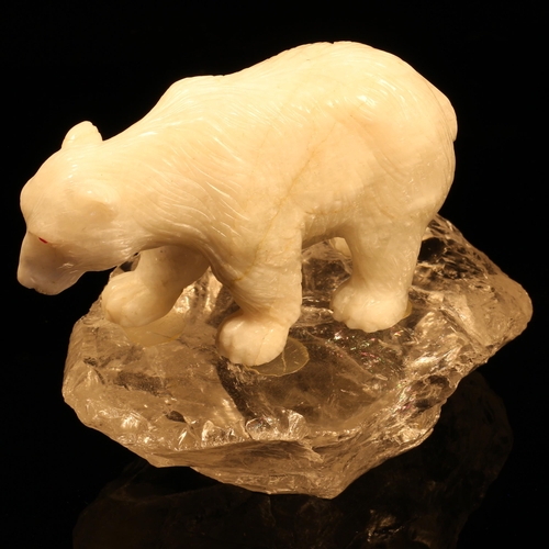 1258 - Alfred Lyndhurst Pocock (1882 - 1962), a white onyx carving, of a polar bear, four square upon a roc... 