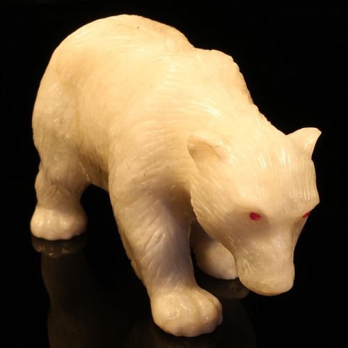 1258 - Alfred Lyndhurst Pocock (1882 - 1962), a white onyx carving, of a polar bear, four square upon a roc... 