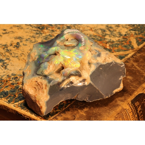 1246 - Alfred Lyndhurst Pocock (1882 - 1962), a rough opal carving, of a lizard on a rock, unsigned, 7cm wi... 