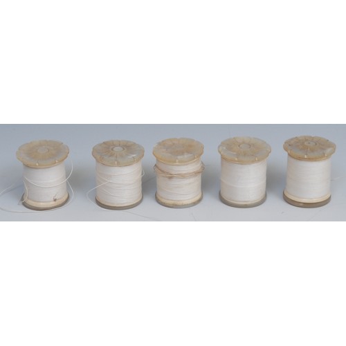 1196 - A set of five 19th century mother of pearl cotton reel bobbins, each carved as a lotus, 3.5cm long, ... 