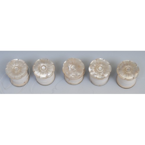 1196 - A set of five 19th century mother of pearl cotton reel bobbins, each carved as a lotus, 3.5cm long, ... 