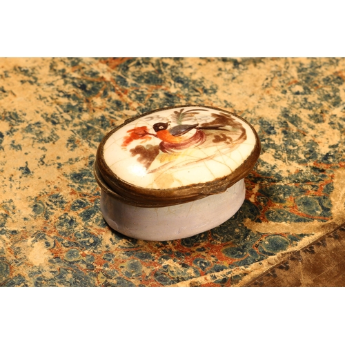 1191 - A George III South Staffordshire enamel oval patch box, hinged cover painted with a bird, pale blue ... 