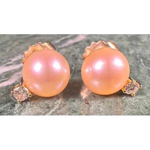 975 - A pair of diamond solitaire and cultured pearl earrings, each stone approximately 0.15ct, the stems ... 