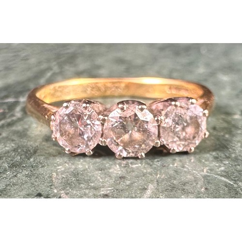 986 - An 18ct gold three-stone diamond ring, the stones claw set, total carat weight approximately 1ct, si... 