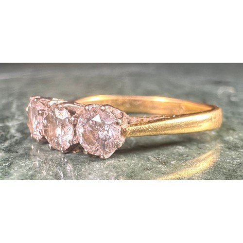 986 - An 18ct gold three-stone diamond ring, the stones claw set, total carat weight approximately 1ct, si... 