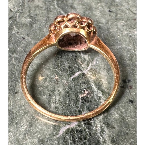 1004 - An 18ct gold and diamond flowerhead ring, the central stone flanked by 8 further smaller stones, app... 