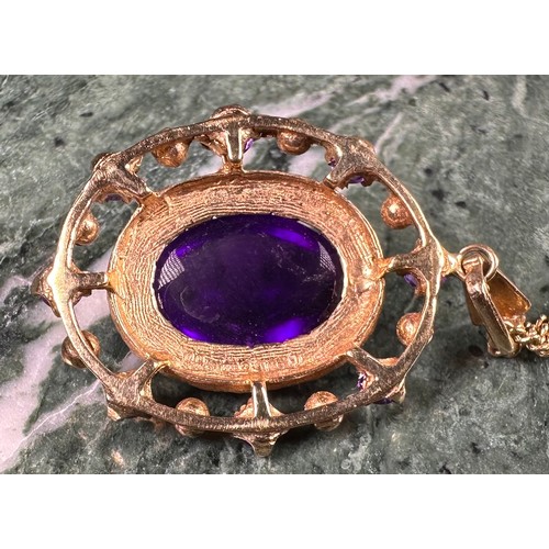 991 - A Victorian style 9ct gold oval amethyst and seen pearl pendant, the large central amethyst cabochon... 