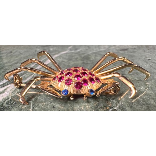 963 - A gold coloured metal crab brooch, the carapace set with 21 circular red facet cut stones, the eyes ... 