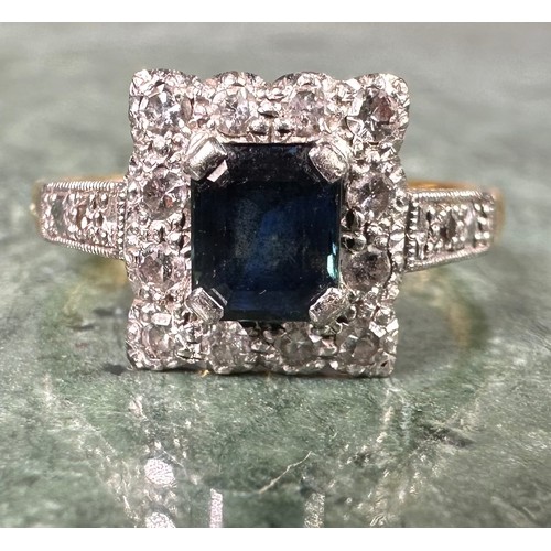 1011 - An 18ct gold, platinum and sapphire ring, the rectangular tablet centered with a cushion cut sapphir... 