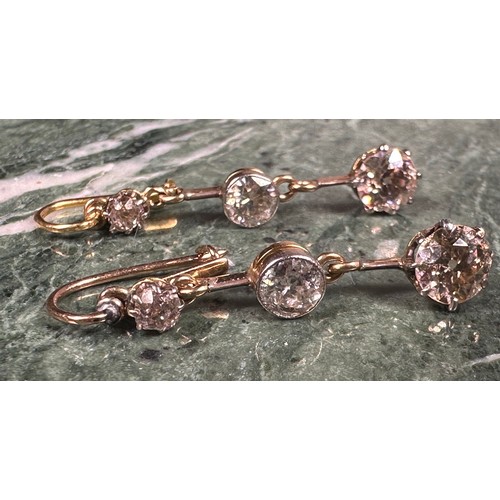 973 - A pair of diamond drop earrings, each set with three graduated old, mixed and brilliant cut diamonds... 