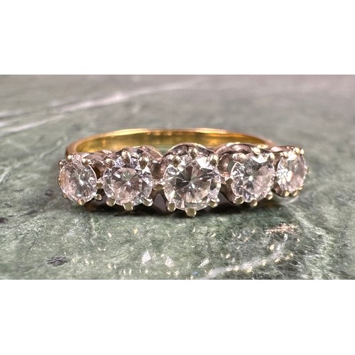 950 - A diamond ring, set with five graduated round brilliant cut diamonds, total estimated diamond weight... 