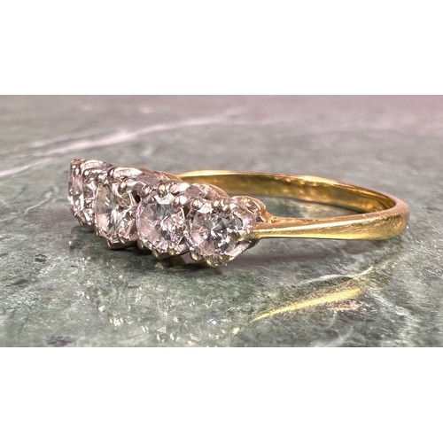 950 - A diamond ring, set with five graduated round brilliant cut diamonds, total estimated diamond weight... 