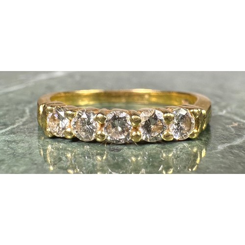 947 - A diamond ring, linear set with five round brilliant cut diamonds, total estimated diamond weight ap... 