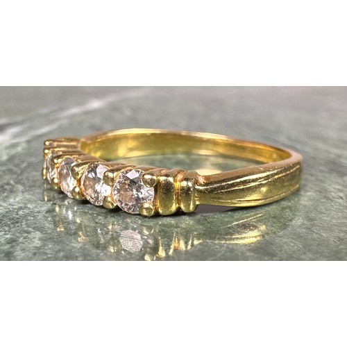 947 - A diamond ring, linear set with five round brilliant cut diamonds, total estimated diamond weight ap... 