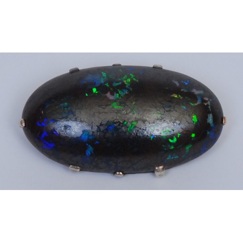 1028 - An opal brooch, the oval stone claw set, silver mount, 4.5cm wide