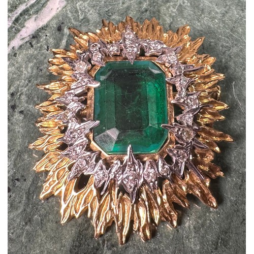 1026 - An emerald, diamond and gold coloured metal sunburst brooch, the central doublet within an irregular... 