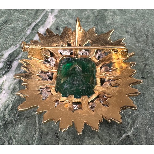 1026 - An emerald, diamond and gold coloured metal sunburst brooch, the central doublet within an irregular... 