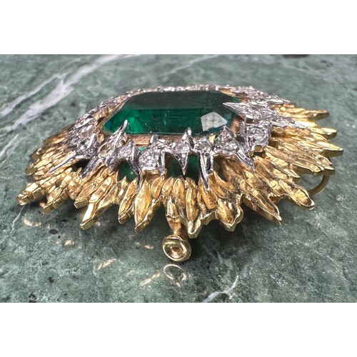 1026 - An emerald, diamond and gold coloured metal sunburst brooch, the central doublet within an irregular... 