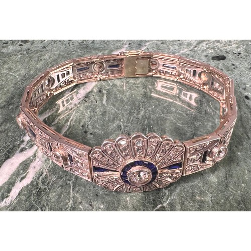 1016 - An Art Deco diamond and sapphire panel bracelet in the manner of Cartier, each panel centered with a... 