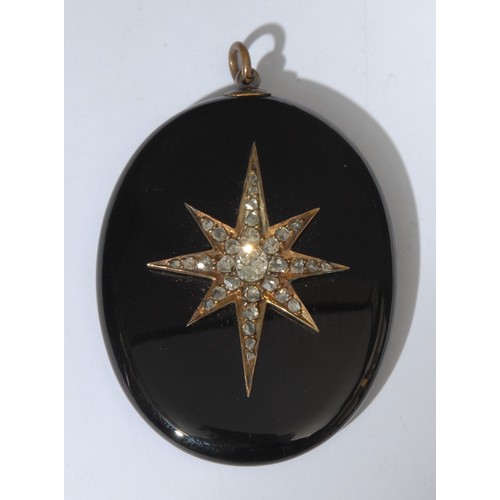 990 - A Victorian obsidian and diamond oval mourning pendant, eight point star crest encrusted with thirty... 