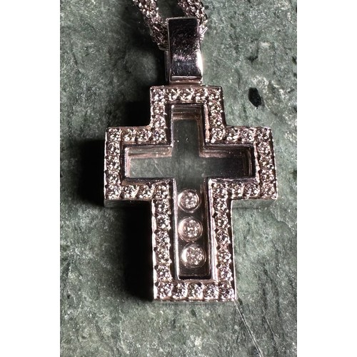 1012 - An 18ct white gold openwork cross pendant, set with round brilliant cut stones enclosing a further t... 