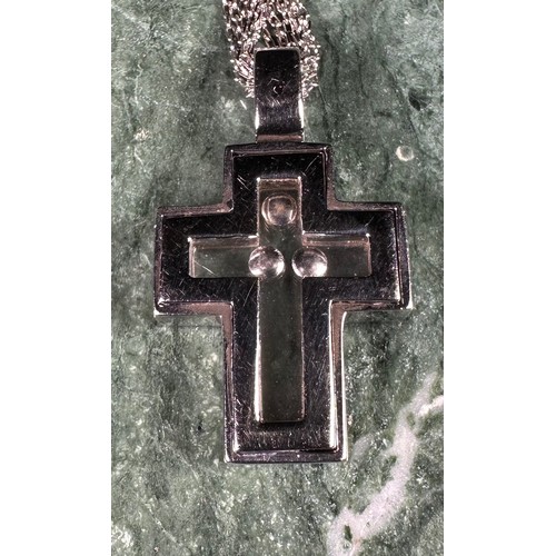 1012 - An 18ct white gold openwork cross pendant, set with round brilliant cut stones enclosing a further t... 