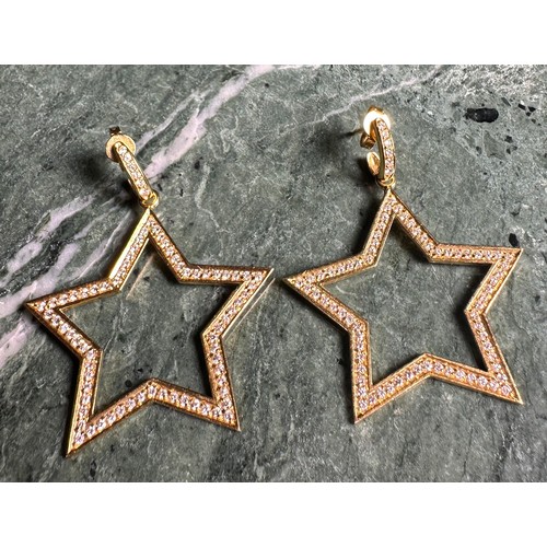 977 - A pair of 18ct gold and diamond star earrings, pave set with diamond chips, 11g gross