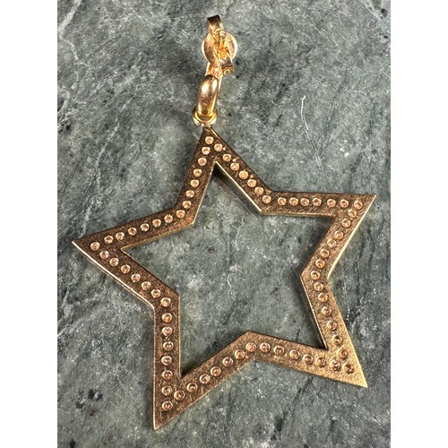 977 - A pair of 18ct gold and diamond star earrings, pave set with diamond chips, 11g gross