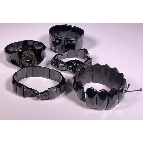 992 - A Victorian Whitby Jet bangle bracelet; four other similar