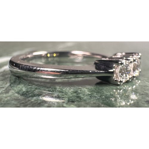 952 - A diamond ring, set with three round brilliant certified diamonds, colour F-G, clarity SI2, total di... 