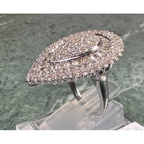 966 - A large diamond teardrop cluster ring, pave set with baguette and round brilliant cut diamonds, tota... 