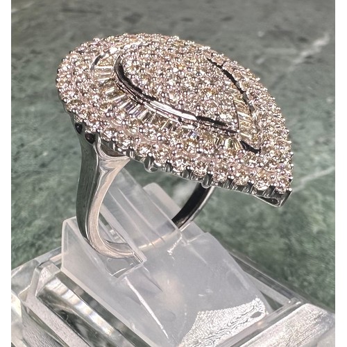 966 - A large diamond teardrop cluster ring, pave set with baguette and round brilliant cut diamonds, tota... 