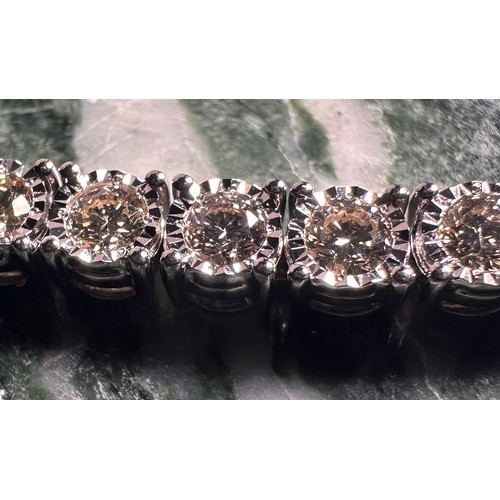 960 - A diamond tennis bracelet, set with forty seven round brilliant cut diamonds, total estimated diamon... 