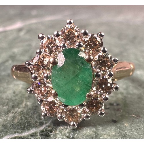 1024 - An emerald and diamond cluster ring, central oval mixed cut emerald approx 0.85ct, surrounded by ten... 