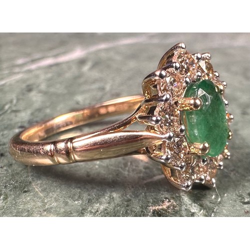 1024 - An emerald and diamond cluster ring, central oval mixed cut emerald approx 0.85ct, surrounded by ten... 