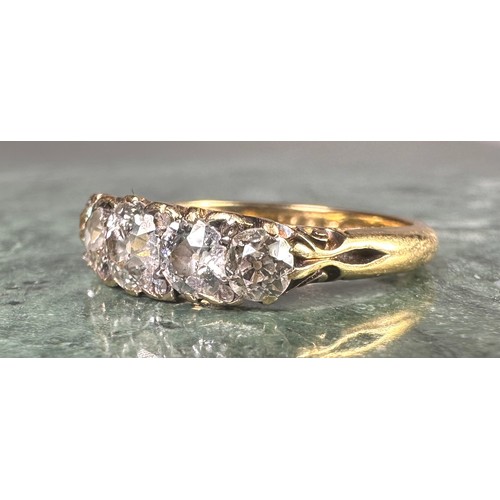 1010 - An 18ct gold graduated five stone diamond ring, the central brilliant cut stone approximately 0.4ct,... 