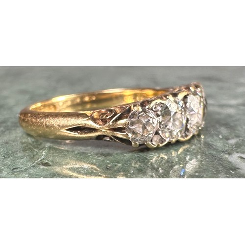 1010 - An 18ct gold graduated five stone diamond ring, the central brilliant cut stone approximately 0.4ct,... 