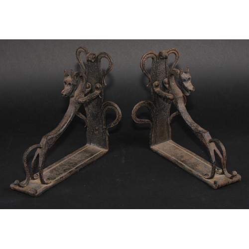 1161 - A pair of Arts and Crafts wrought iron book ends, each worked with a stylised dog, the uprights with... 