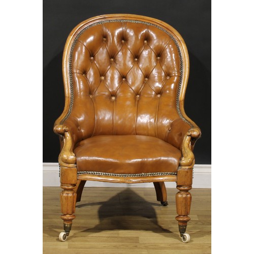 2082 - A Victorian walnut library chair, stuffed-over leather upholstery, deep-button back, turned and reed... 