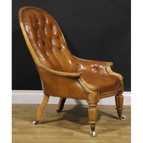 2082 - A Victorian walnut library chair, stuffed-over leather upholstery, deep-button back, turned and reed... 