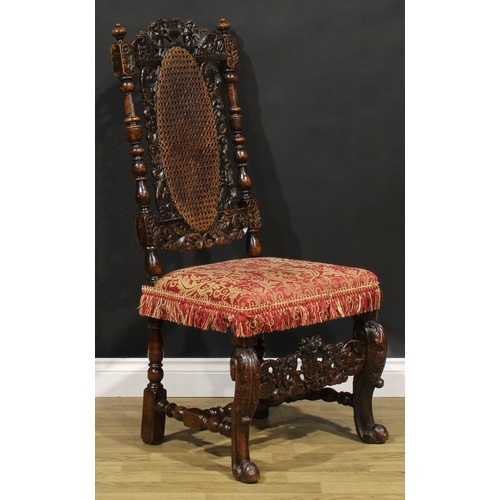 2083 - An early 18th century walnut side chair, the cresting rail carved with a pair of putti supporting a ... 