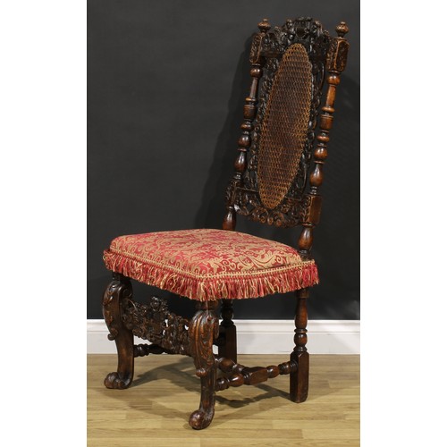 2083 - An early 18th century walnut side chair, the cresting rail carved with a pair of putti supporting a ... 