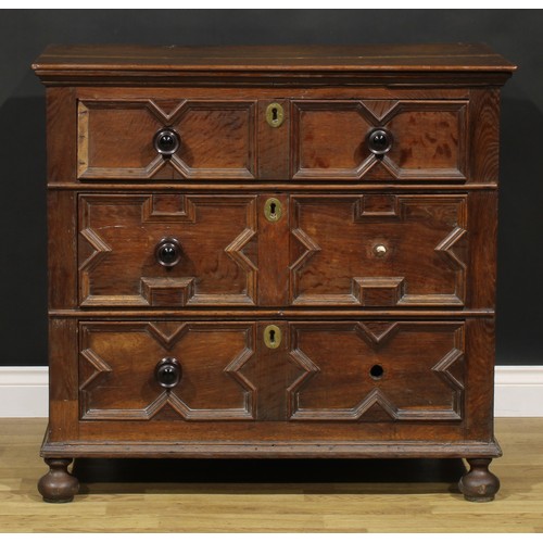 2084 - An early 18th century oak chest, oversailing rectangular top above three drawers, applied with geome... 