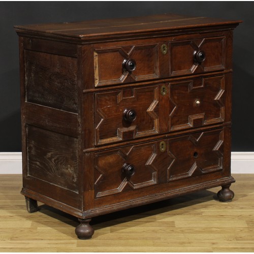 2084 - An early 18th century oak chest, oversailing rectangular top above three drawers, applied with geome... 