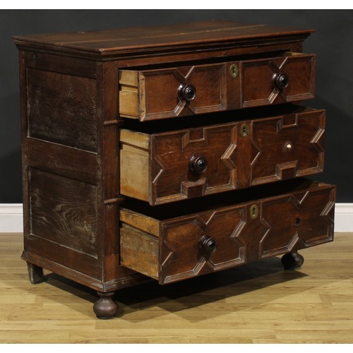 2084 - An early 18th century oak chest, oversailing rectangular top above three drawers, applied with geome... 