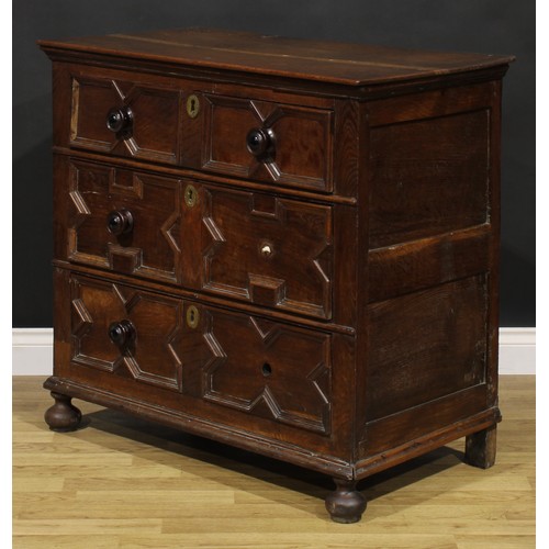 2084 - An early 18th century oak chest, oversailing rectangular top above three drawers, applied with geome... 