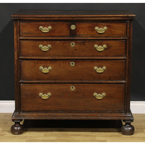 2085 - An early 18th century oak chest, three plank top with moulded edge above two short and three long gr... 